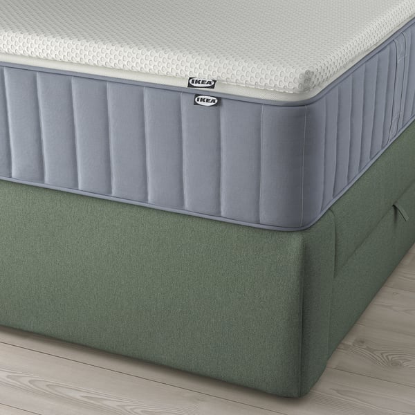 Ikea LILLFJÄLLET bed with cushioned headboard and integrated storage.