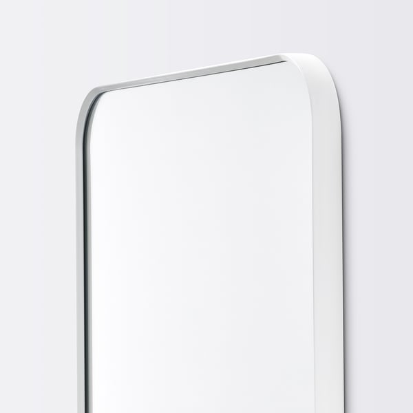 Modern, sleek mirror with rounded edges. Elegant white frame, suitable for any room.
