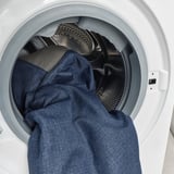 Washer with blue jeans in drum.