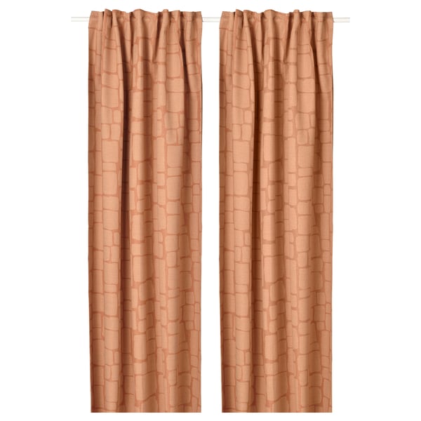 Two tan patterned curtains hang straight, offering privacy and light control.