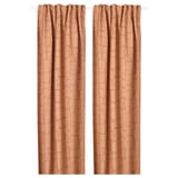 Two tan patterned curtains hang straight, offering privacy and light control.