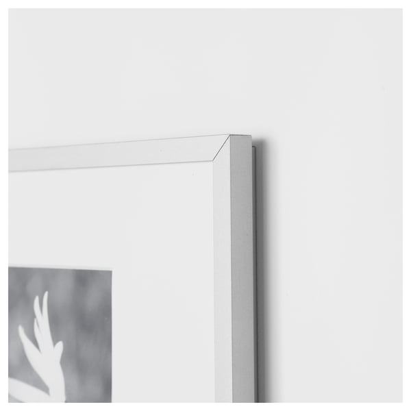 Close-up of a sleek, silver picture frame corner with thin metal edge, showcasing its high-quality design.