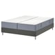 Split king bed with white mattress and gray base.