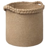 A MÄVINN jute basket in natural beige. It’s hand-woven with sturdy handles and a braided rim, perfect for storage and home decoration.