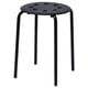 A black MARIUS stool with a round seat and four metal legs. Its designed for stacking and made of steel and plastic.
