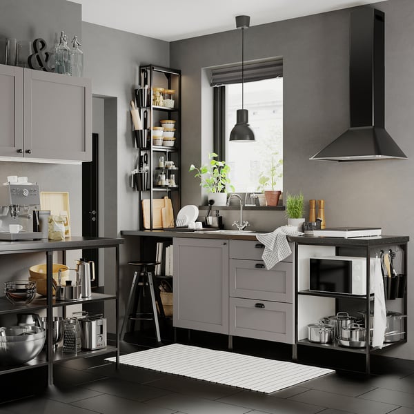 Modern kitchen with black and grey tones, featuring sleek cabinets, stainless steel appliances, and open shelving.