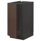 An ikea METOD kitchen base cabinet in dark brown with wooden grain texture and square shape. It has a single door and metal hinge dampers.