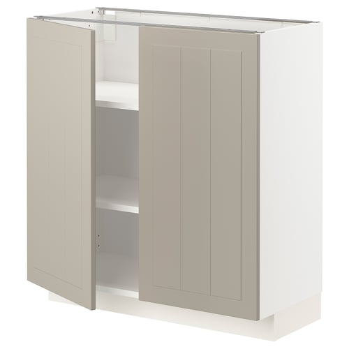 A beige METOD cabinet with two doors open, revealing shelves inside.