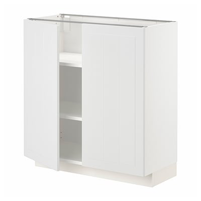 A white METOD kitchen cabinet. It vertical grooves and two open doors revealing adjustable shelves.