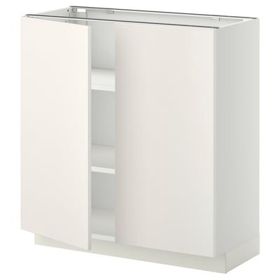 A white METOD kitchen cabinet with two open doors, showcasing inner shelves.
