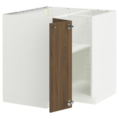 Modern white kitchen cabinet with walnut door, metal hinges.