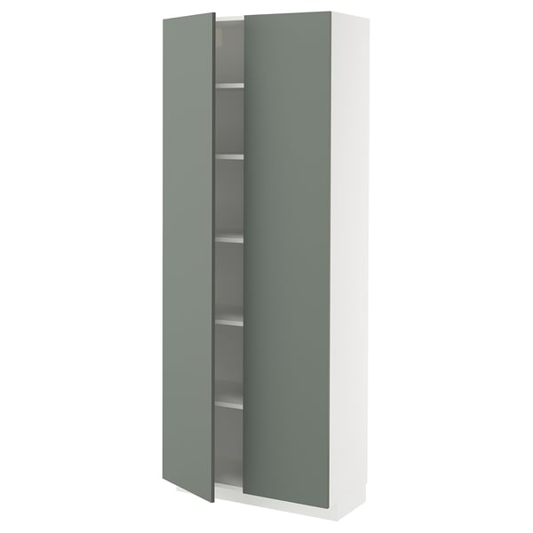 Depicts a white and green kitchen cabinet from the METOD system, featuring an adjustable shelf and a green door.