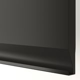 Modern kitchen cabinet in matte black; sleek, chamfered edges, sturdy construction.