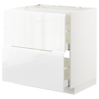 White glossy kitchen cabinet, METOD series, with integrated handles and smooth wooden appearance.