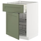 Green-grey kitchen cabinet unit with two wire baskets, partially open door.