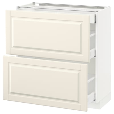 A white METOD kitchen cabinet with off-white bodbyn drawers featuring beveled edges.
