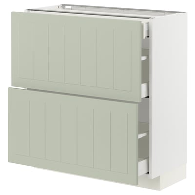 A light green METOD kitchen cabinet with smooth, crafted panels and multiple drawers. It has a modern, elegant design.