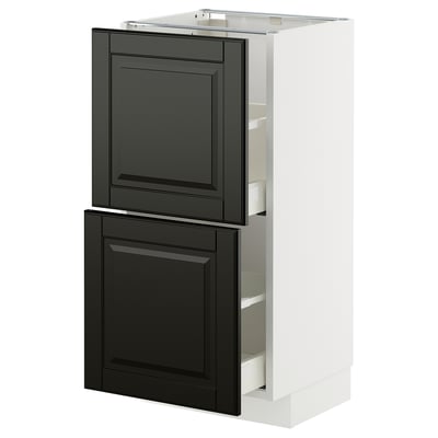 A white METOD kitchen cabinet with black bodbyn fronts, featuring two drawers and a cabinet door.