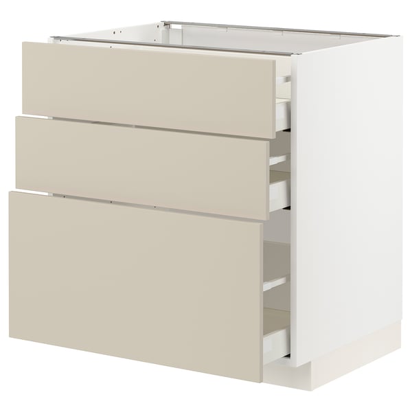 A white and beige METOD kitchen cabinet with three self-closing drawers in a modern, minimalist design.