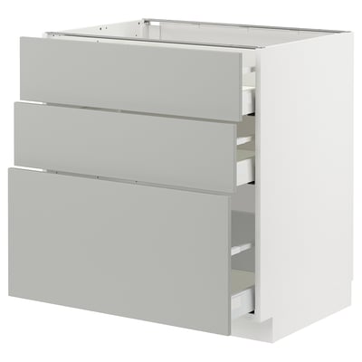 Modern light grey kitchen cabinet with three drawers and sleek design.