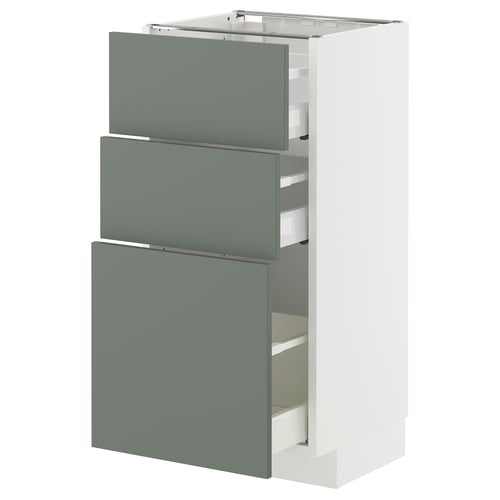 A METOD kitchen cabinet with three green-gray drawers and a white frame. Its modern design smooth, self-closing drawers.