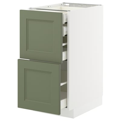 A white and green kitchen cabinet from the METOD system with two doors and two drawers in a modern design.