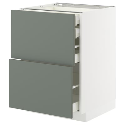 Modern kitchen cabinet: white, grey-green drawers, three open.