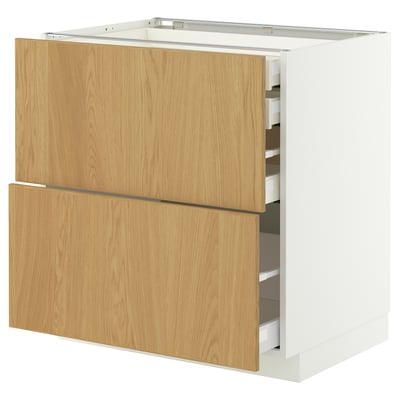 A METOD kitchen cabinet in white and light wood. It has both drawers and shelves.