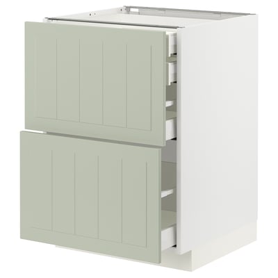 Modern kitchen cabinet in light green with open drawers.