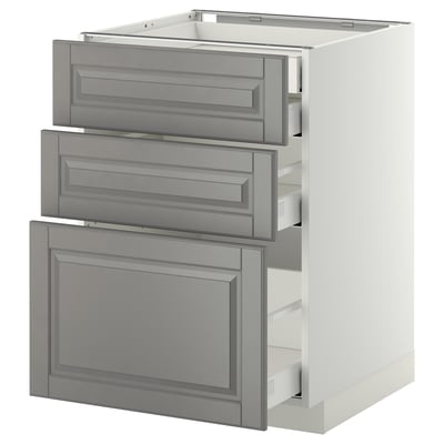 A white METOD kitchen unit with grey drawers. The unit has three drawers and a cabinet, featuring beveled edges and a traditional design.