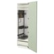 Green kitchen cabinet with black shelves and drawers.