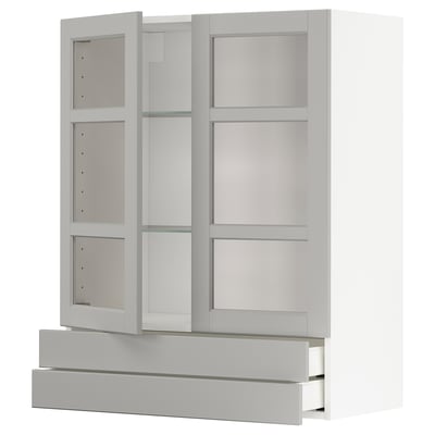 White ikea METOD kitchen unit with glass doors and drawers.