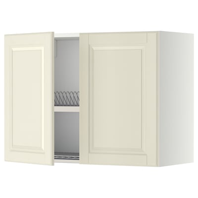 An off-white METOD kitchen wall cabinet with beveled edges and an open door revealing an adjustable shelf and a steel dish drainer.
