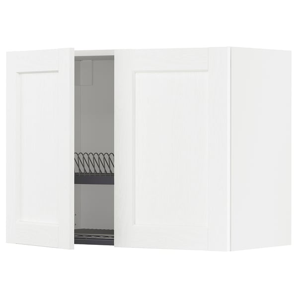 A white, modern cabinet system with one door open, revealing a wire dish rack inside.