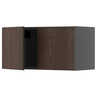 Dark brown wooden cabinet with one open door, part of ikeas METOD kitchen system.