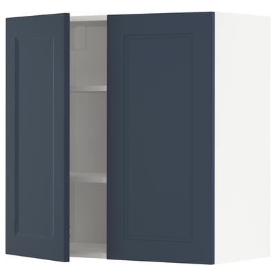 Blue kitchen cabinet with one door open, revealing an empty interior with one adjustable shelf. The cabinet is square-shaped with a modern design.