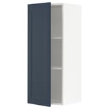 A METOD kitchen cabinet with an open blue door, featuring a modern traditional design in dark blue and white.