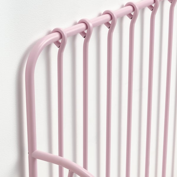 Image shows a close-up of a pink, extendable bed frame, highlighting its sturdy steel construction and smooth, powder-coated surface.