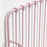 Image shows a close-up of a pink, extendable bed frame, highlighting its sturdy steel construction and smooth, powder-coated surface.