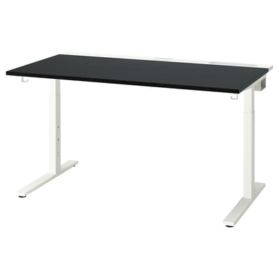 Black MITTZON height-adjustable desk with white legs, sleek rectangular surface, and built-in cable management tray.