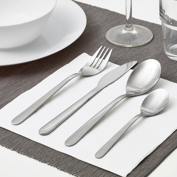 Silverware set laid on cloth: fork, knife, spoon, teaspoon, ready for use.