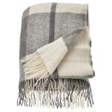 A MYRULL wool throw blanket in light grey and white with a checkered pattern, featuring fringed edges.