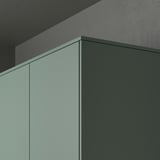 Modern kitchen cabinet close-up with matt grey-green NICKEBO panels and decorative strips hiding lighting units.