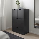 Modern black NORDLI chest of drawers in bedroom, taller than rug, featuring drawers & cabinets.