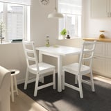 Small white dining set in bright room. NORDVIKEN table seats 4, chairs have high backs.