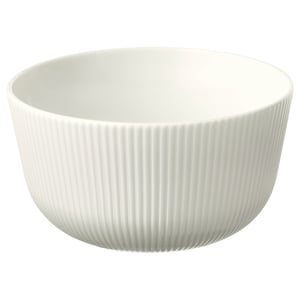 A white OFANTLIGT ceramic bowl made of feldspar porcelain, featuring vertical fluted design for grip and aesthetic appeal.