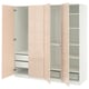A modern, light pink PAX wardrobe with three open sections, showing shelves and drawers. Sleek, minimal design with soft-close hinges.