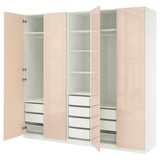 A light pink, modern, PAX wardrobe with open doors, revealing shelves and drawers, set against a white background.
