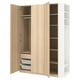 An open light wooden PAX wardrobe with shelves and drawers.