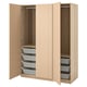 An open light beige wooden PAX wardrobe with mesh drawers and fabric boxes inside.